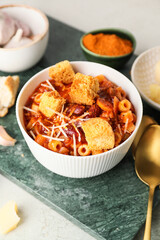 Bowl with tasty pasta and beans on table