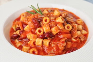 Bowl with tasty pasta and beans, closeup