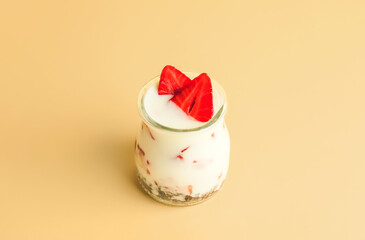 Tasty strawberry dessert in jar on color background