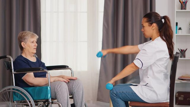 Senior woman in wheelchair doing physical rehabilitation with with doctor. Training, sport, recovery and lifting, old person retirement home, healthcare nursing, health support, social assistance