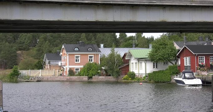 4K video of Porvoo vintage red wooden buildings, Porvoo Cathedral, yachts and boats in Porvoonjoki River near town center on sunny summer day in Finland, northern Europe