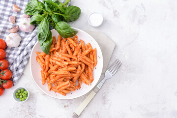 Plate with tasty pasta and tomato sauce on white background