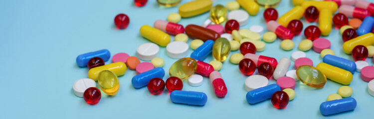 Multi-colored tablets, capsules, vitamins, supplements. Сoncept of treatment and healthcare.