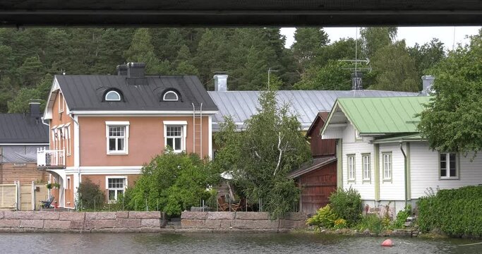 4K video of Porvoo vintage red wooden buildings, Porvoo Cathedral, yachts and boats in Porvoonjoki River near town center on sunny summer day in Finland, northern Europe