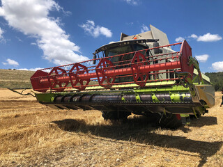Fototapeta premium Combine harvester parked in a large Wheat field.