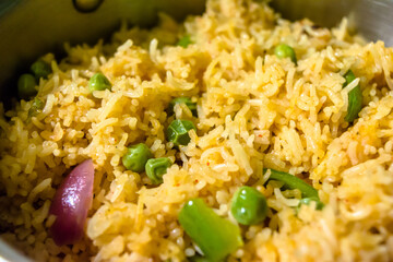 Homemade Chinese fried rice with vegetables, Veg Schezwan Fried Rice, peas, peppers, green beans, carrot. Selective Focus, Top view
