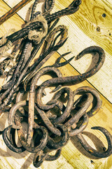 set iron hooks double-sided sharp design forge closeup close-up on a wooden background