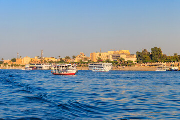 Naklejka premium Tourist boat sailing on the Nile river in Luxor, Egypt