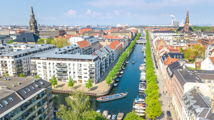 Naklejka na ściany i meble Beautiful aerial view of Copenhagen skyline from above, Nyhavn historical pier port and canal with color buildings and boats in the old town of Copenhagen, Denmark 