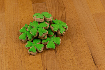 St. Patrick's Day heap of gingerbread clover with mastic on a wooden surface
