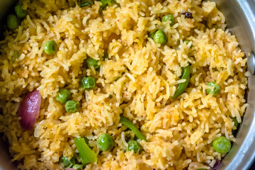 Homemade Chinese fried rice with vegetables, Veg Schezwan Fried Rice, peas, peppers, green beans, carrot. Selective Focus, Top view
