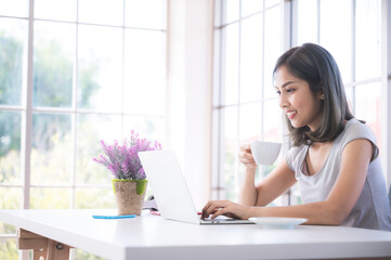 Beautiful young woman works online for the job conference with friend colleague at cozy living room...