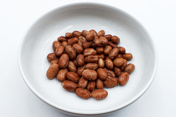 Baked italian borlotti beans in a bowl, isolated on white