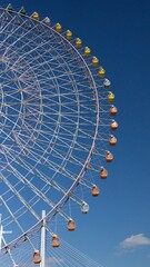 Giant ferris wheel against blue skies in Osaka, Japan
