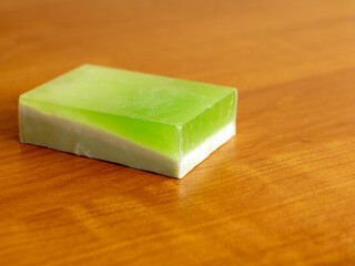 Green handmade soap on a wooden background. Soap for spa close up