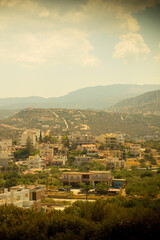 Fototapeta na wymiar vertical photo vintage tinted greek city among hill design postcard