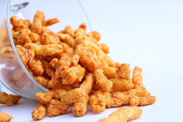 yummy tasty crunchy snacks drop from a transparent bowl