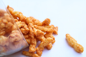 yummy tasty crunchy snacks drop from a transparent bowl