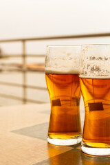 light beer in glasses stands on the table of a street cafe