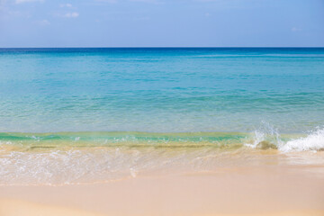 Beautiful clean beach with summer outdoor day light, clean sea water on find sand beach, blue sea water and clear blue sky, nature and environmental concept background