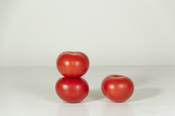 Three red tomatoes on a white background. Tomatoes for pizza. 