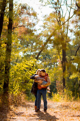Fototapeta premium family with child walking in autumn Park. walks in nature