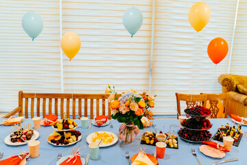 festive table at summer children's party in country house. decoration balloons.