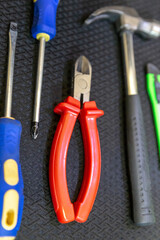 pair of screwdrivers, nippers with red handles and a hammer manual tool locksmith vertical set