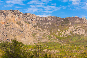 Fototapeta na wymiar gorge walk in the mountains among high cliffs sunny day trekking