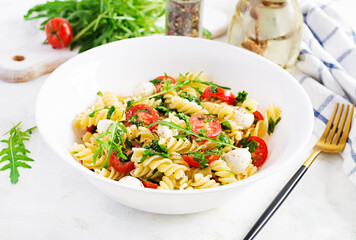 Pasta salad. Fusilli Pasta - Caprese salad with tomato, mozzarella and basil.