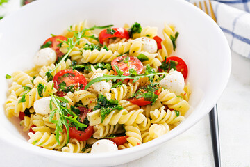 Pasta salad. Fusilli Pasta - Caprese salad with tomato, mozzarella and basil.