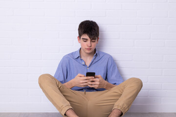 young teenager man with mobile phone