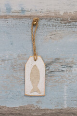 Fish Tag On Distressed Wood Background
