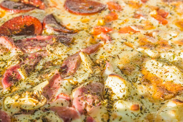 Obraz na płótnie Canvas fresh cooked hot pizza close up with tomatoes, pepperoni and mushrooms in the delivery box. fast food summer concept