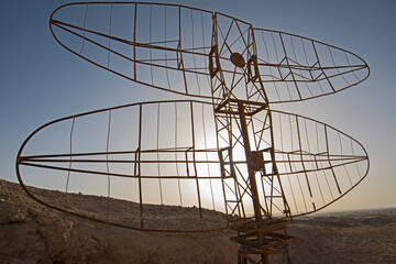 Old military radar aerial abandoned in remote african desert