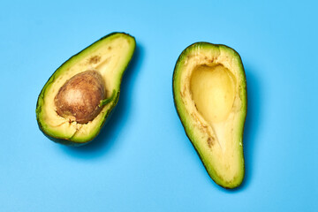 Sliced avocado on a blue background.