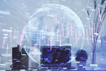 Stock market graph on background with desk and personal computer. Multi exposure. Concept of financial analysis.