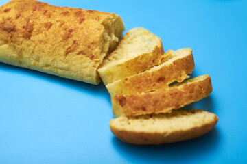 Sliced ciabatta on a blue background.
