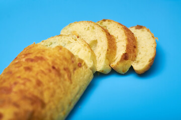 Sliced ciabatta on a blue background.
