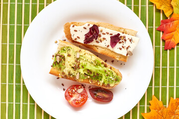 Toasted baguette with avocado and cheese.