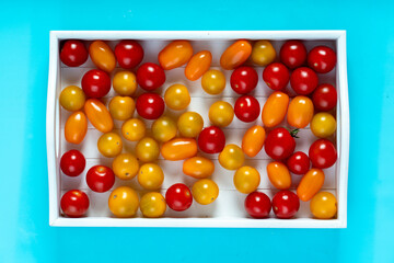 Top view of cherry tomatoes in small wooden crate