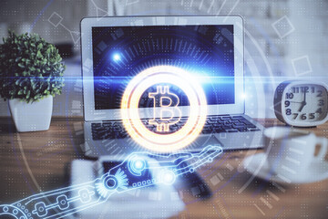 Multi exposure of blockchain and crypto economy theme hologram and table with computer background....