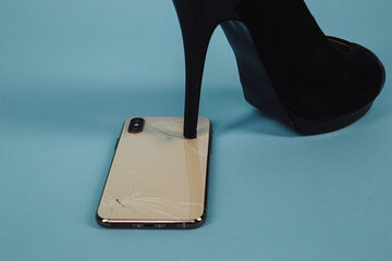 Broken phone from heel. Woman tread on the mobile on the floor