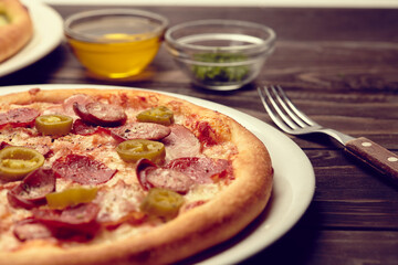 tasty pizza on the wooden background