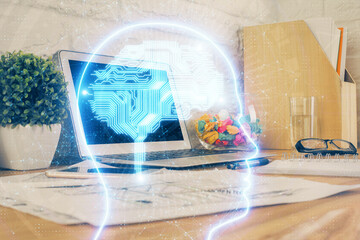 Double exposure of work space with computer and human brain drawing hologram. Brainstorm concept.