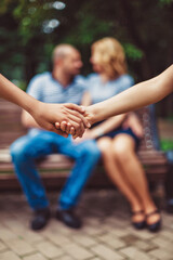 children on the background of parents hold hands