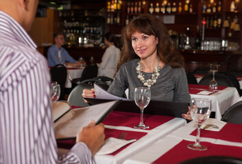 Woman with male friend in restaurant