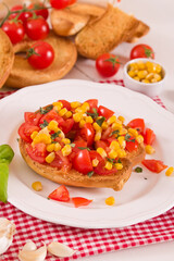 Friselle with tomatoes and mais.
