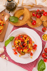 Friselle with tomatoes and mais.
