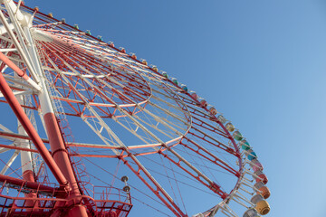 A ferris wheel and blue sky background.